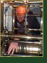 Lighthouse Consultant Jim Woodward inspects the operation of the Point Reyes 1st Orderclockworks. Click to view enlarged image